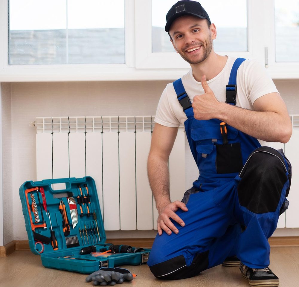 Professional young repairman in special uniform with tools is in